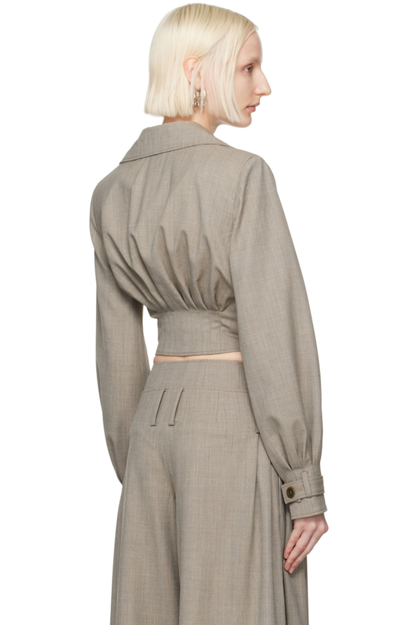 Wool sharkskin jacket.

· Funnel neck converts to spread collar
· Button fastenings at collar
· Two-way zip closure
· Pleats at cropped hem
· Padded shoulders
· Loop and detachable button tab at cuffs
· Full viscose-blend twill lining

Supplier color: Grey