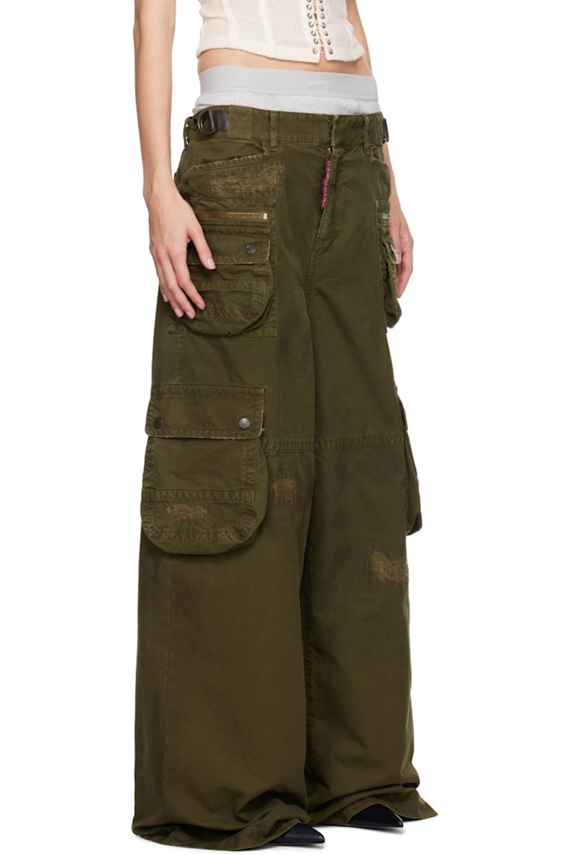 Cotton canvas cargo pants. Distressing and buffed leather trim throughout. 

· Belt loops
· D-rings at partially elasticized waistband
· Four-pocket styling 
· Logo flag at zip-fly
· Cargo and zip pockets at front legs
· Gusset at inseam
· Adjustable press-stud tabs at back waistband 
· Two-way zip vent at back
· Logo-engraved antiqued bronze-tone hardware

Supplier color: Khaki