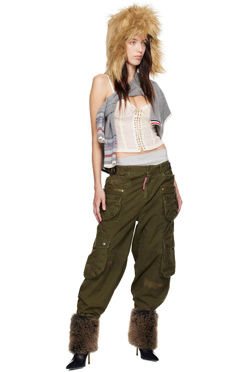 Cotton canvas cargo pants. Distressing and buffed leather trim throughout. 

· Belt loops
· D-rings at partially elasticized waistband
· Four-pocket styling 
· Logo flag at zip-fly
· Cargo and zip pockets at front legs
· Gusset at inseam
· Adjustable press-stud tabs at back waistband 
· Two-way zip vent at back
· Logo-engraved antiqued bronze-tone hardware

Supplier color: Khaki