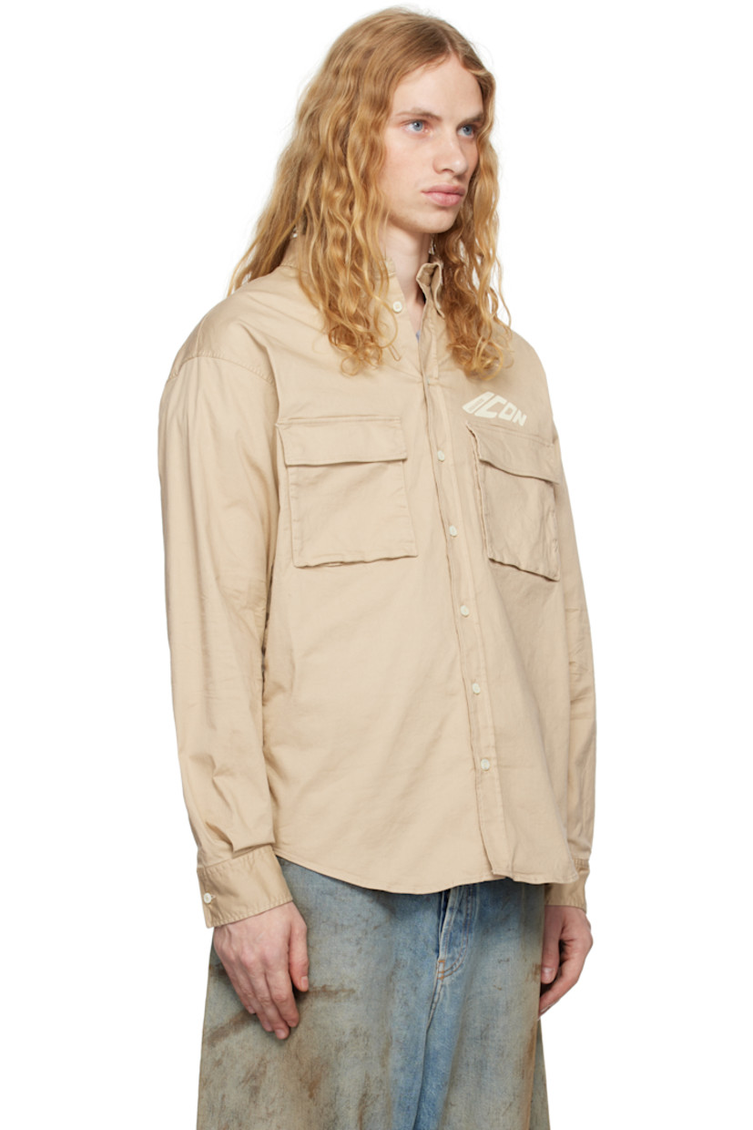 Stretch crinkled cotton twill shirt. 

· Spread collar
· Button closure
· Logo and text bonded at chest
· Flap pockets
· Shirttail hem
· Dropped shoulders
· Pleats at single-button barrel cuffs
· Box pleat at back yoke 

Supplier color: Beige