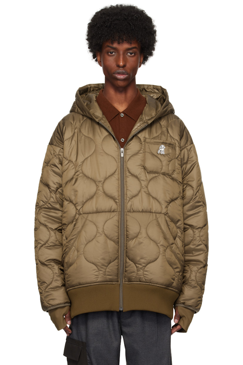 Padded and quilted polyester satin jacket.

· Hood at collar
· Zip closure
· Embroidered logo patch at chest
· Patch pockets
· Rib knit hem
· Thumbhole at inset jersey cuffs
· Locker loop at back collar
· Full satin lining

Supplier color: Brown