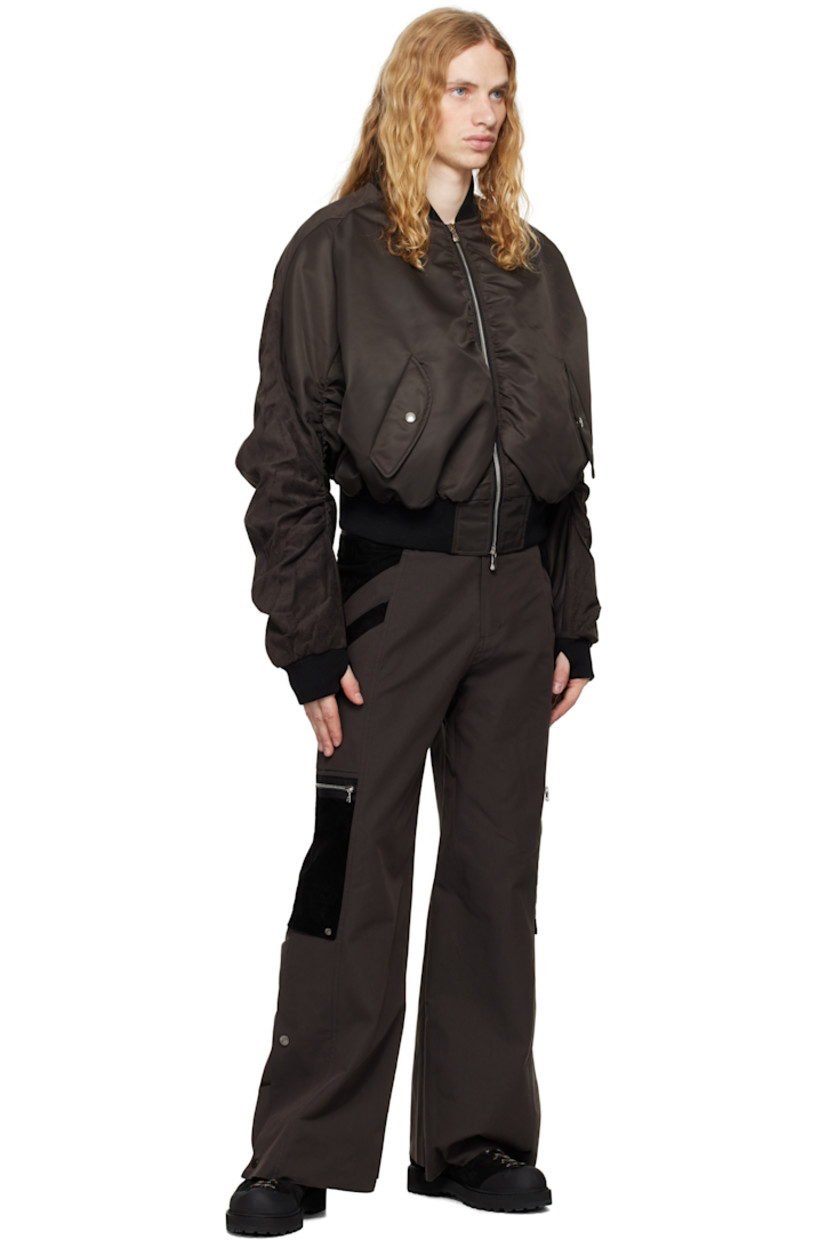Polyester- and cotton-blend twill and suede cargo pants. 

· Paneled construction 
· Belt loops
· Adjustable cinch tabs at waistband
· Four-pocket styling
· Zip-fly
· Patch and zip pockets at outseams
· Press-stud expansion panel and raw edge at cuffs

Supplier color: Dark brown