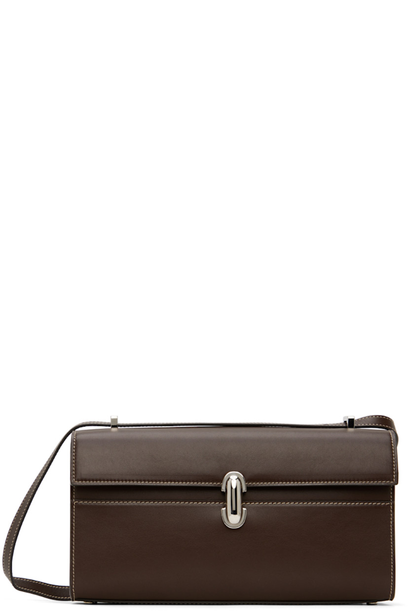 Buffed calfskin shoulder bag in brown.

· Convertible crossbody strap
· Bumper studs at base
· Turn-lock flap
· Patch pocket at interior
· Contrast stitching in off-white
· H5.5" x W10" x D2.25"

Supplier color: Coffee