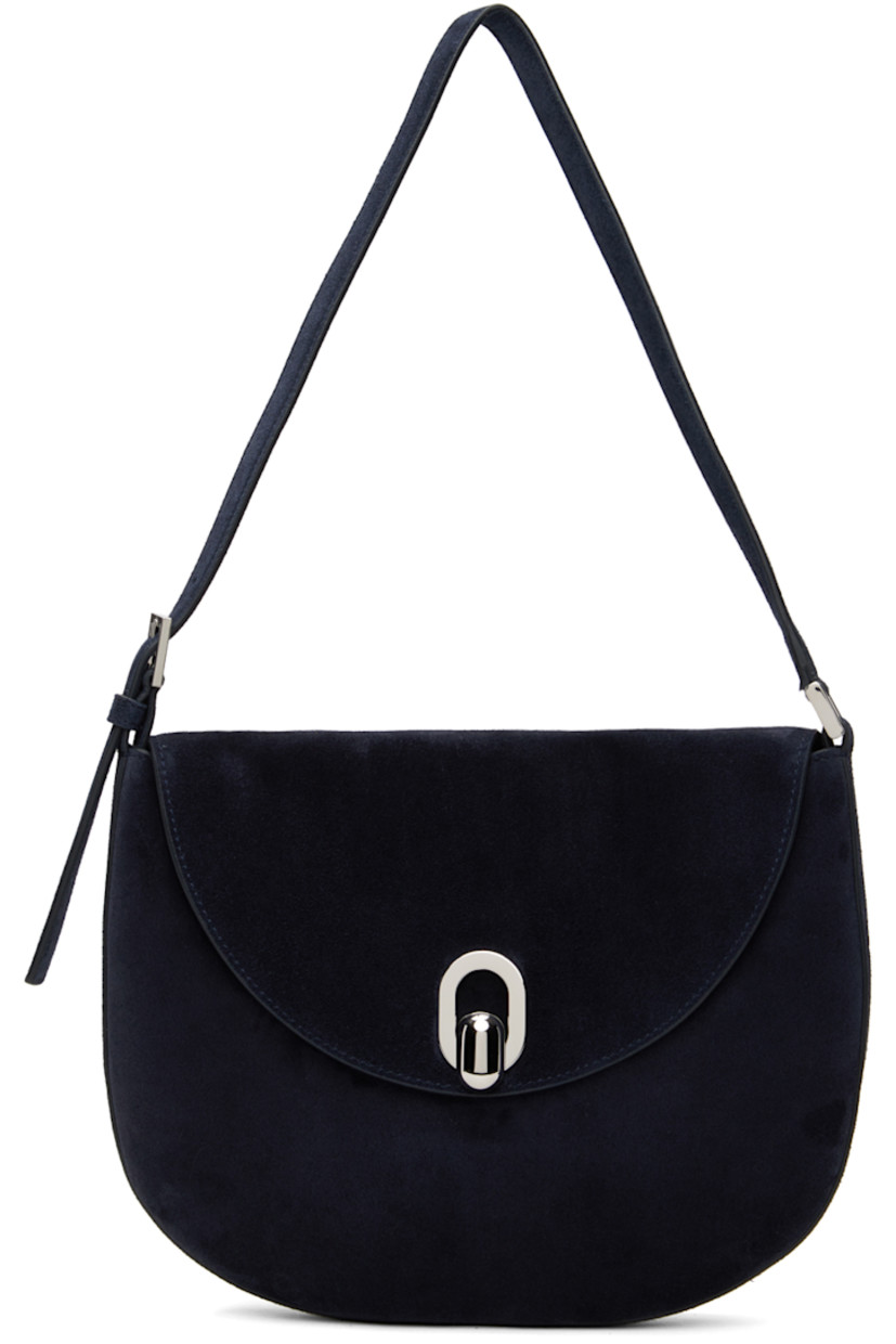 Calfskin suede shoulder bag in navy.

· Adjustable shoulder strap
· Magnetic tab-slot flap
· Card slot at interior
· Silver-tone hardware
· H7.5" x W10" x D0.75" 

Supplier color: Navy
