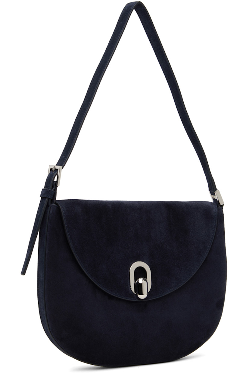 Calfskin suede shoulder bag in navy.

· Adjustable shoulder strap
· Magnetic tab-slot flap
· Card slot at interior
· Silver-tone hardware
· H7.5" x W10" x D0.75" 

Supplier color: Navy