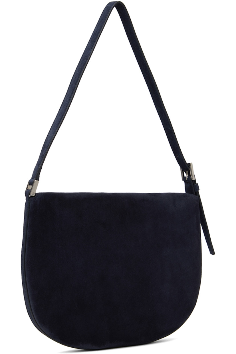 Calfskin suede shoulder bag in navy.

· Adjustable shoulder strap
· Magnetic tab-slot flap
· Card slot at interior
· Silver-tone hardware
· H7.5" x W10" x D0.75" 

Supplier color: Navy