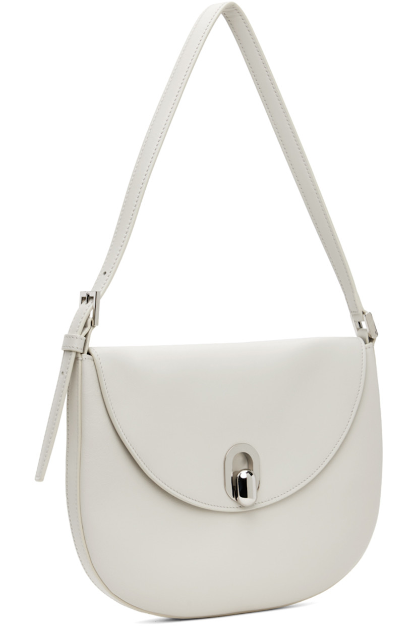 Grained calfskin shoulder bag in off-white.

· Adjustable shoulder strap
· Magnetic tab-slot flap
· Card slot at interior 
· Silver-tone hardware
· H7.5" x W10" x D0.75"

Supplier color: Ivory