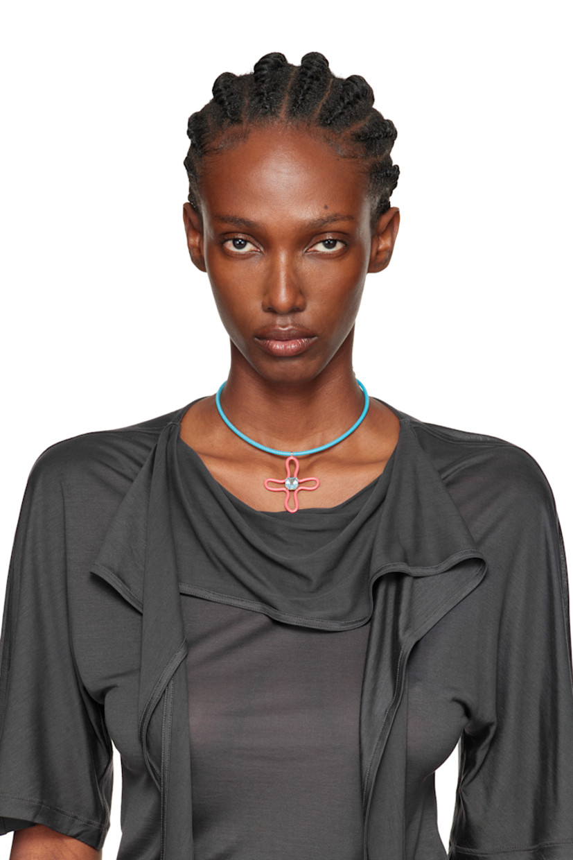 Handcrafted leather cord choker-style necklace in blue. Graphic pendant in pink enameled sterling silver.

· Prong-set princess-cut 5.38 ct topaz
· 9k gold hardware
· Toggle fastening
· L16.5"

Supplier color: Pink/Turquoise
