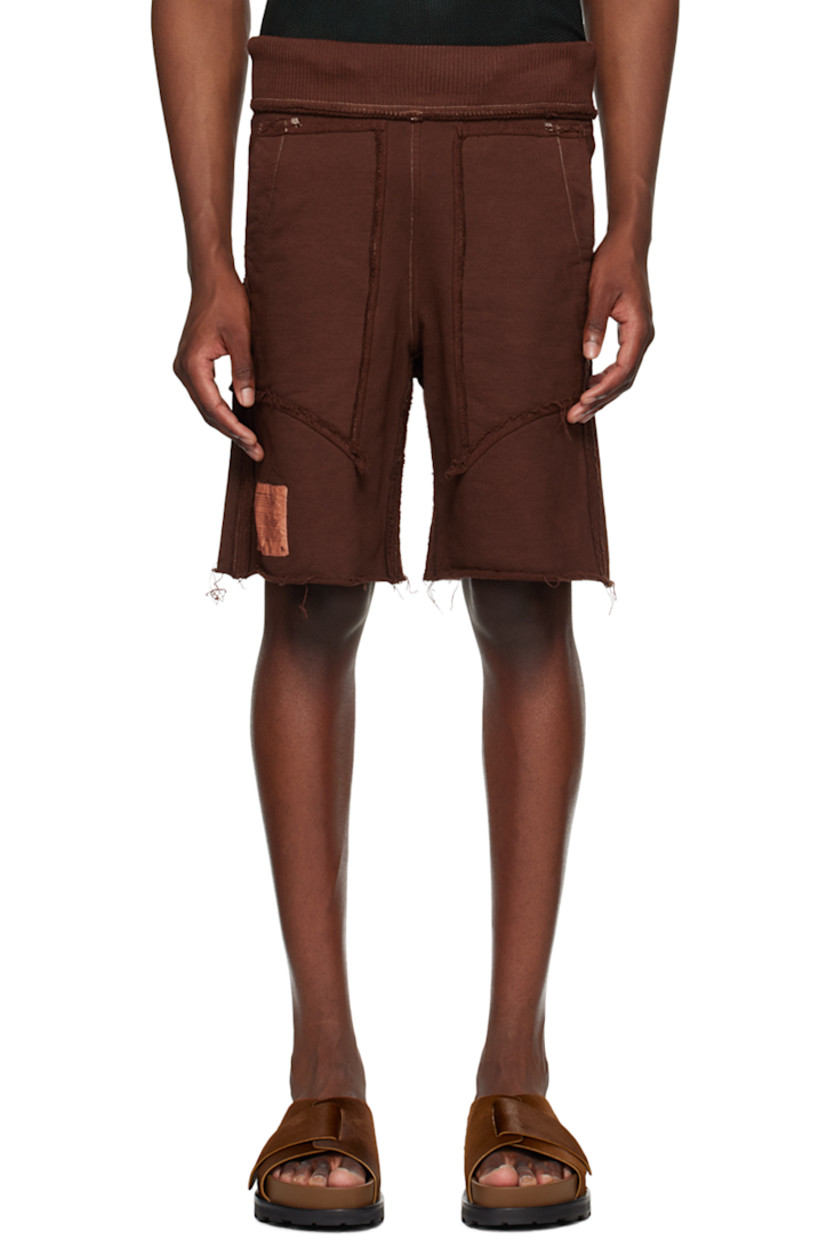 Garment-dyed French terry shorts. Exposed seams and raw edges throughout.

· Paneled construction 
· Concealed drawstring at rib knit waistband
· Four-pocket styling
· Logo patch at hem
· Contrast stitching in white 

Supplier color: Brown