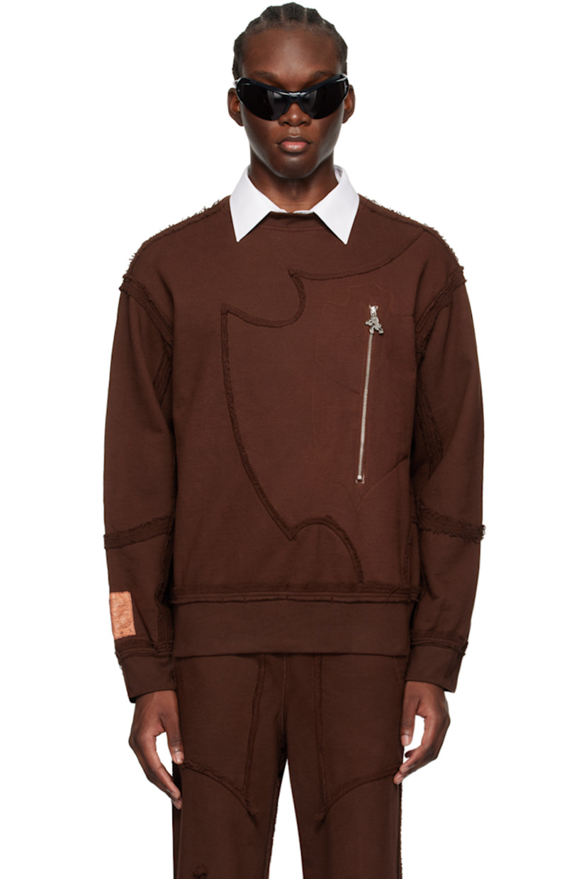 French terry sweatshirt. Exposed seams and raw edges throughout.

· Paneled construction
· Rib knit crewneck, hem, and cuffs
· Zip pocket and graphic charm at front
· Logo patch at cuff

Available exclusively at SSENSE.

Supplier color: Brown