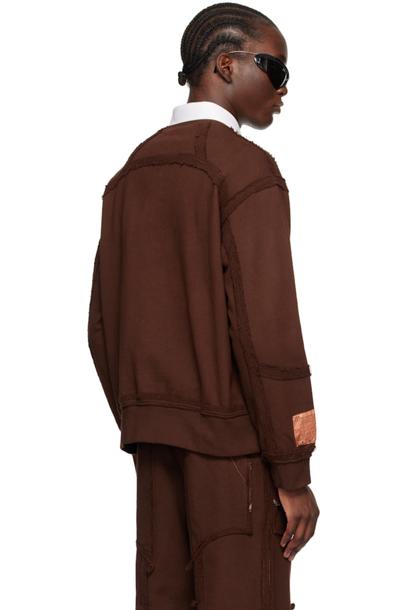 French terry sweatshirt. Exposed seams and raw edges throughout.

· Paneled construction
· Rib knit crewneck, hem, and cuffs
· Zip pocket and graphic charm at front
· Logo patch at cuff

Available exclusively at SSENSE.

Supplier color: Brown