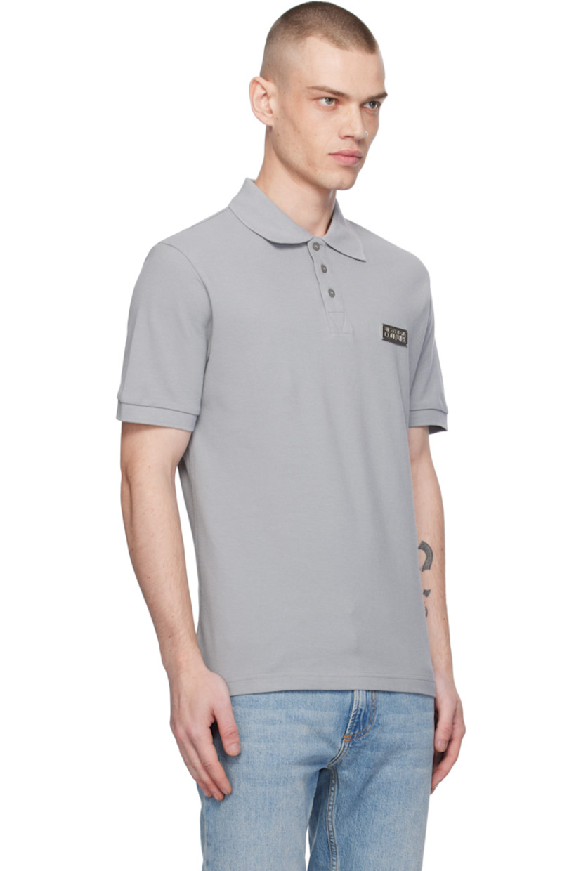Slim-fit cotton piqué polo. 

·  Rib-knit spread collar and cuffs 
· Three-button placket
· Silver-tone logo plaque at chest
· Tennis-tail hem

Supplier color: Grey