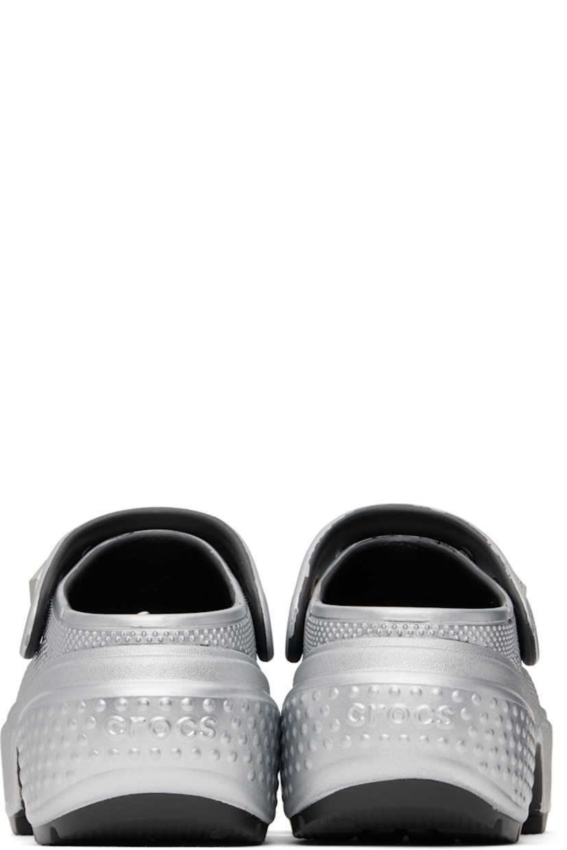 Lightweight Croslite™ foam rubber slip-on loafers in metallic silver tone.

· Perforations and textured detailing throughout
· Detachable studs at logo-embossed slingback strap
· Molded Crocs Comfort™ rubber footbed
· Rubber block heel
· Platform rubber midsole
· Treaded rubber sole
· Platform: H2"
· Heel: H2.75"

Supplier color: Silver