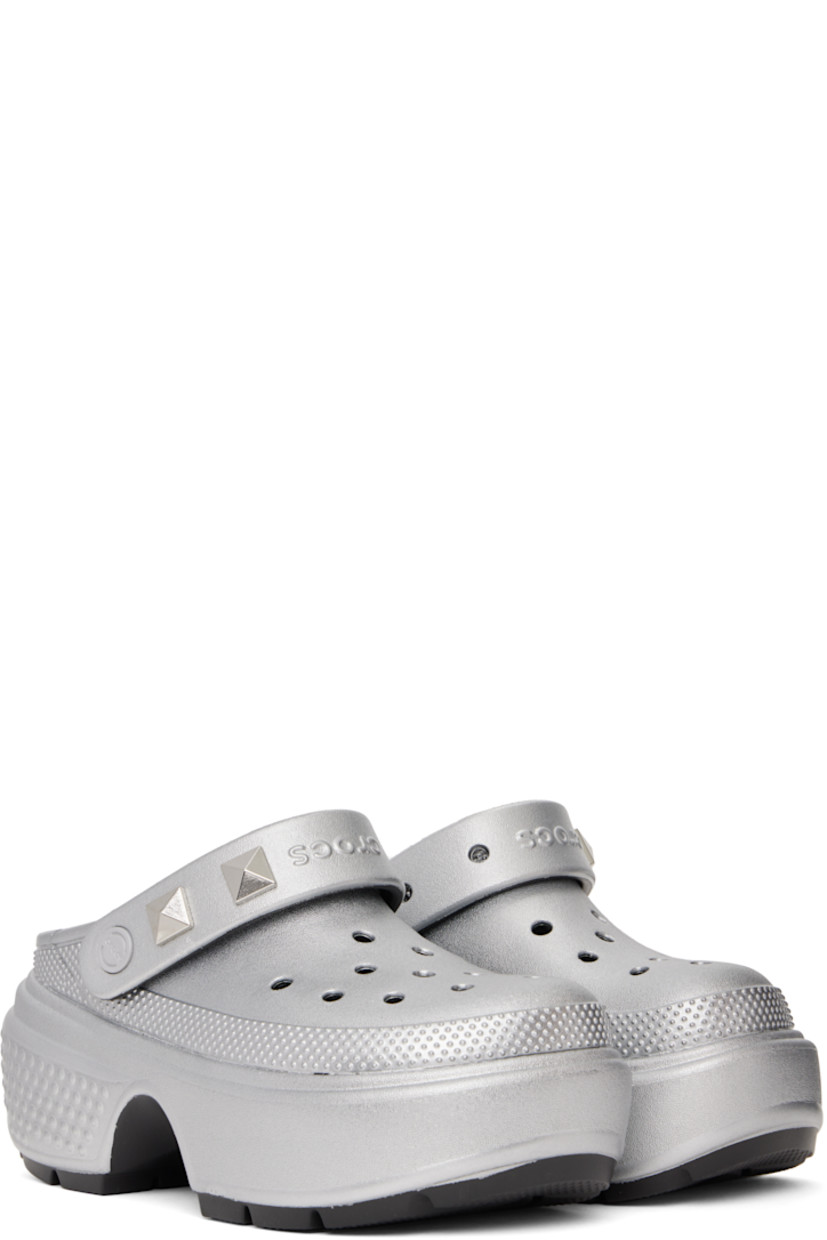 Lightweight Croslite™ foam rubber slip-on loafers in metallic silver tone.

· Perforations and textured detailing throughout
· Detachable studs at logo-embossed slingback strap
· Molded Crocs Comfort™ rubber footbed
· Rubber block heel
· Platform rubber midsole
· Treaded rubber sole
· Platform: H2"
· Heel: H2.75"

Supplier color: Silver