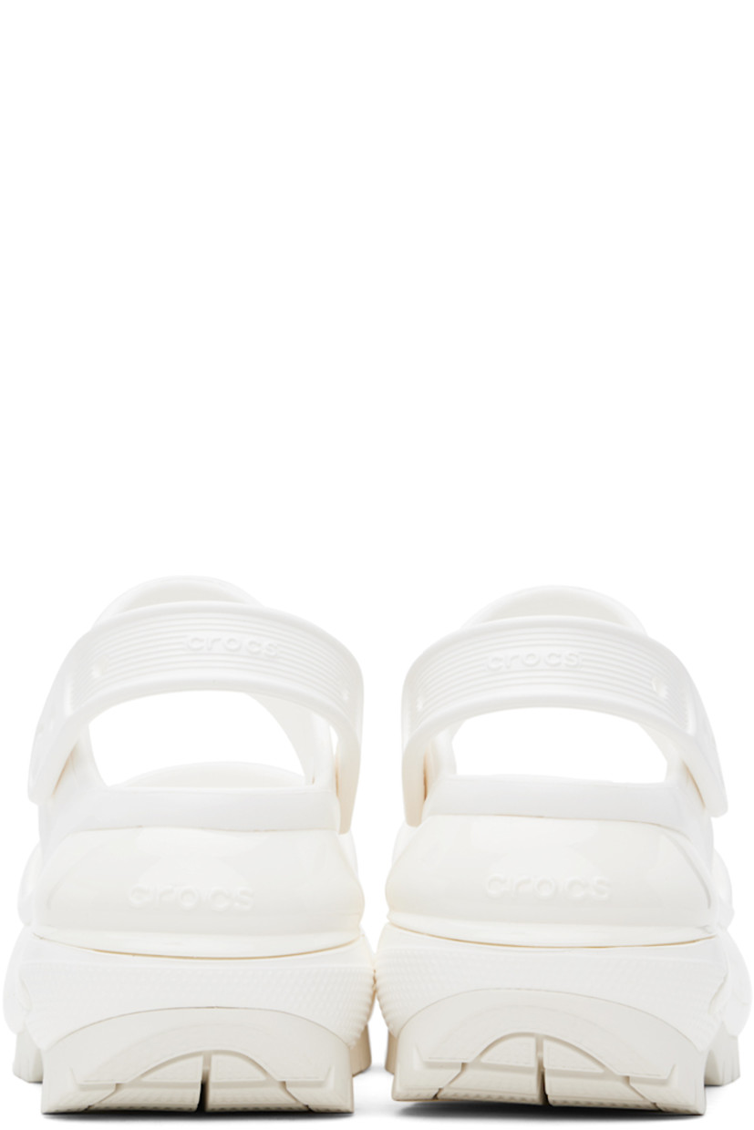 Rubber slip-on flat sandals in white.

· Perforated detailing throughout
· Open toe
· Straps at vamp
· Logo-embossed convertible slingback strap
· Logo embossed at heel
· Molded rubber footbed
· Sculptural platform rubber midsole
· Treaded rubber sole
· Logo-engraved hardware
· Platform: H3"

Supplier color: White