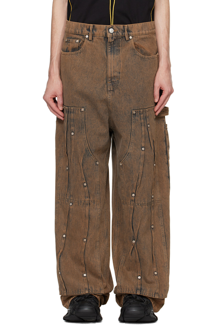 Non-stretch denim jeans. Fading throughout. 

· Twisted belt loops
· Five-pocket styling
· Zip fly
· Reinforced panels at front with pleats and rivets 
· Hammer loop and patch pockets at outseams
· Logo patch at back waistband 

Supplier color: Copper