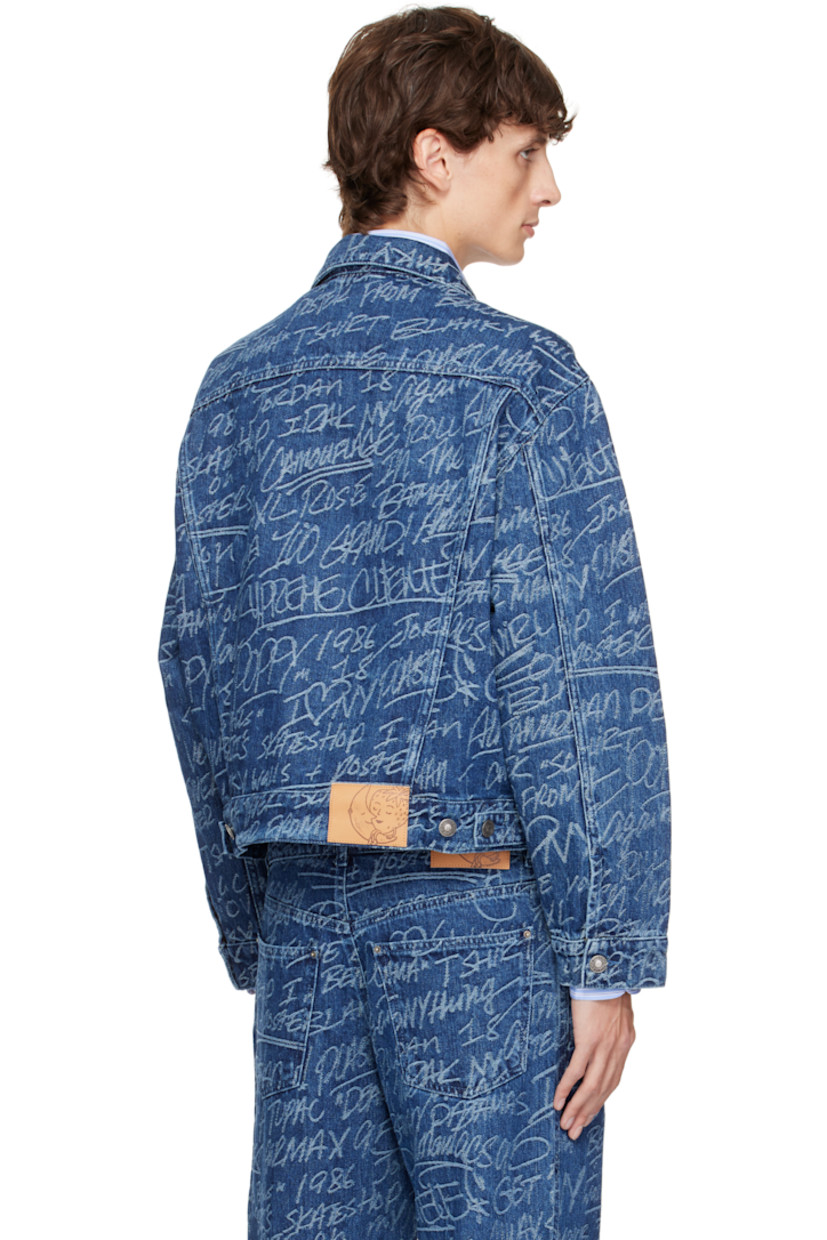 Non-stretch denim jacket. Jacquard graphic pattern and fading throughout.

· Spread collar
· Button closure
· Flap and welt pockets
· Single-button barrel cuffs
· Adjustable button tabs at back hem
· Logo patch at back hem

Featuring artwork by Ben Solomon. 

Supplier color: Dark blue