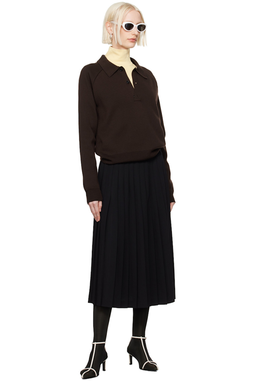 Virgin wool twill skirt. Knife pleats throughout.

· Wrap construction
· Pin-buckle tab at waistband and side
· Unlined

Supplier color: Black