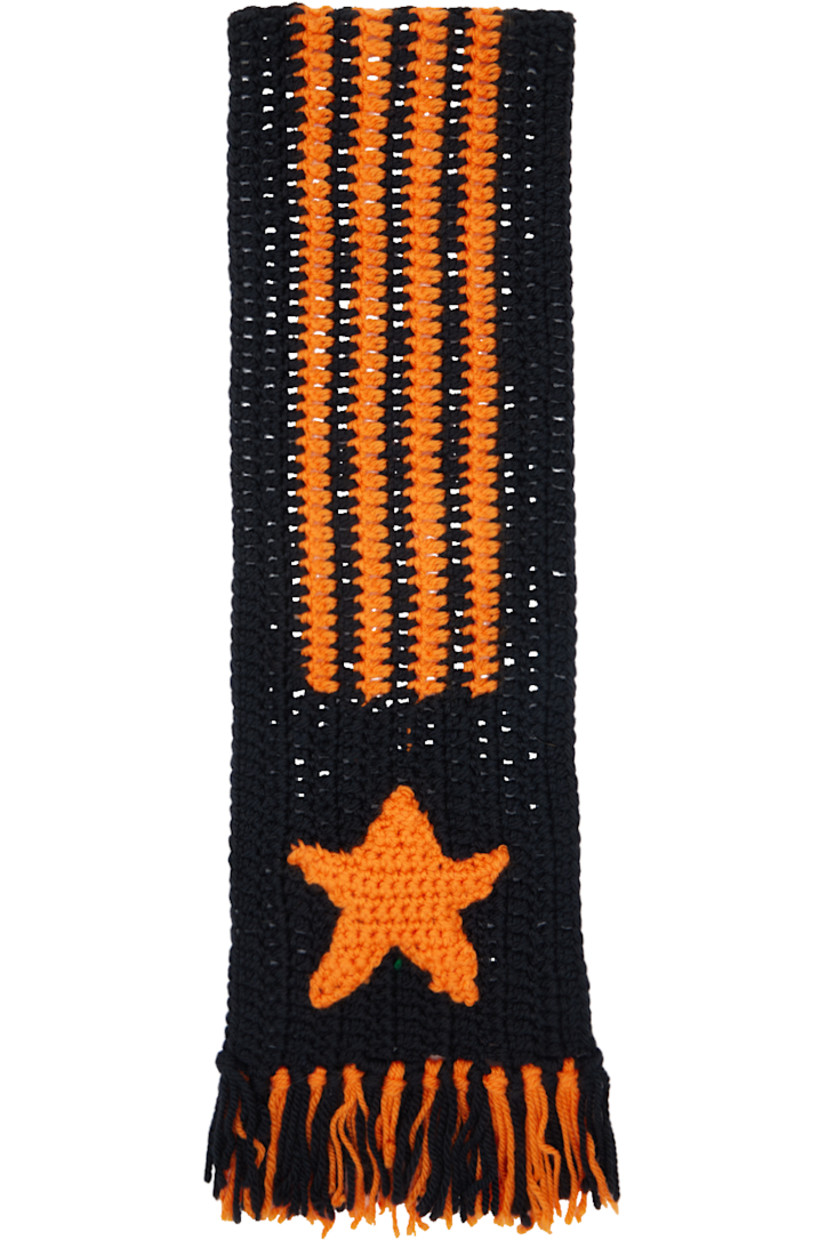 Rectangular crocheted wool scarf in black and orange.

· Stripes at length
· Crocheted stripes and star appliqués at face
· Fringed ends
· L72" x W8"

Part of a limited run of 30. 

Supplier color: Black