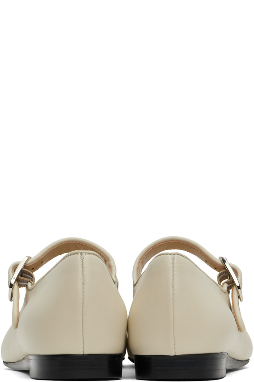 Buffed lambskin Mary Jane-style ballerina flats in off-white.

· Piping at pin-buckle strap and collar
· Logo embossed at cushioned calfskin footbed
· Suede and buffed calfskin lining
· Stacked leather heel with rubber injection
· Leather sole

Supplier color: Ecru