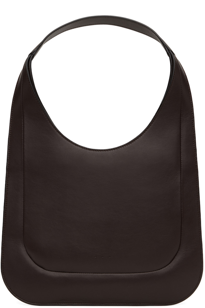 Buffed calfskin shoulder bag in brown.

· Integrated shoulder strap
· Magnetic closure
· Card slot at interior
· Faille lining
· H9.5" x W12"
· Total height: 17.5"

Supplier color: Dark chocolate