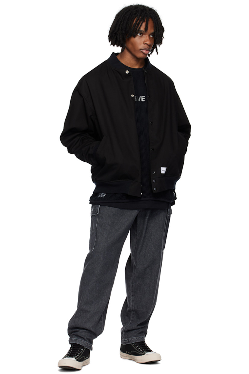Reversible water-repellent polyester- and cotton-blend twill bomber jacket.

Reverse in khaki and navy rayon poplin. Graphic pattern printed throughout.

· Rib knit stand collar, hem, and cuffs
· Press-stud closure
· Welt pockets
· Logo patch at front
· Logo embroidered at back
· Welt pockets at interior

Supplier color: Black