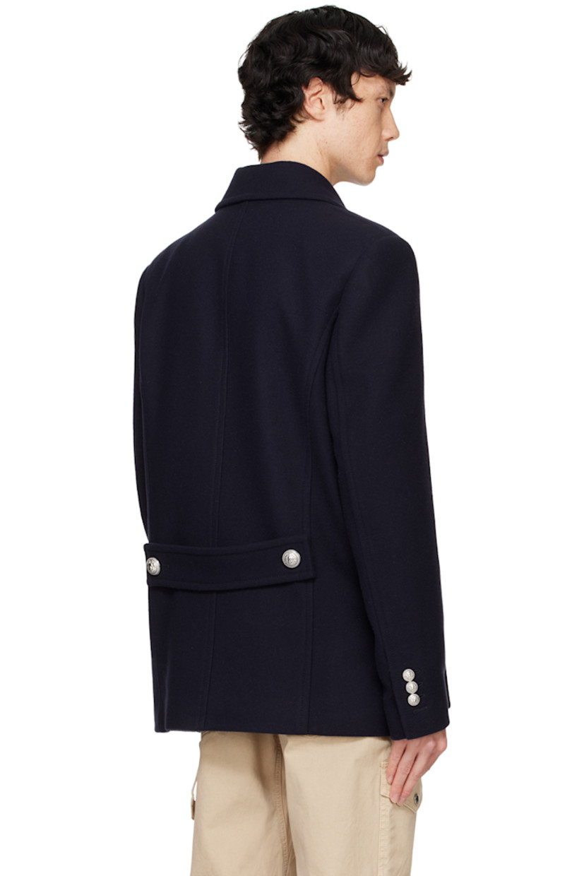 Virgin wool-blend melton peacoat.

· Peaked lapel
· Double-breasted button closure
· Flap pockets
· Padded shoulders
· Logo patch at cuff
· Three-button surgeon's cuffs
· Welt pockets at interior
· Full satin lining
· Graphic silver-tone hardware

Supplier color: Navy