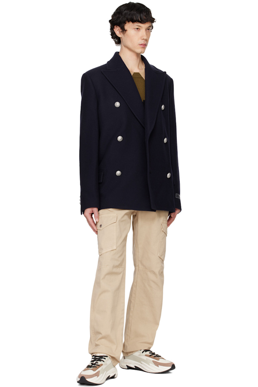 Virgin wool-blend melton peacoat.

· Peaked lapel
· Double-breasted button closure
· Flap pockets
· Padded shoulders
· Logo patch at cuff
· Three-button surgeon's cuffs
· Welt pockets at interior
· Full satin lining
· Graphic silver-tone hardware

Supplier color: Navy