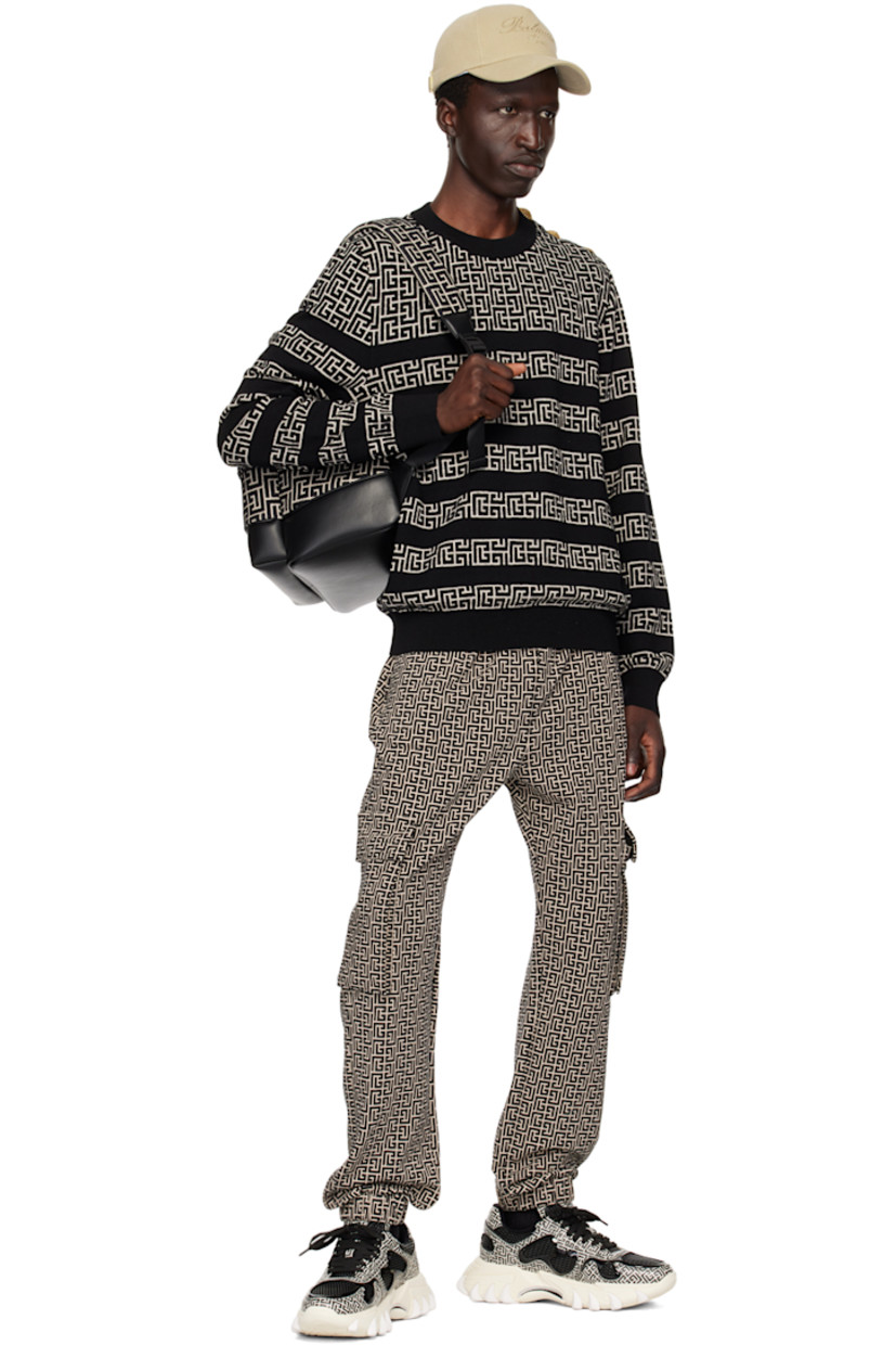 Knit merino wool- and linen-blend sweater. Stripes and jacquard logo pattern throughout. 

· Rib knit crewneck, hem, and cuffs
· Press-stud fastening at shoulder 
· Logo-engraved gold-tone hardware

Supplier color: Ivoire/Noir