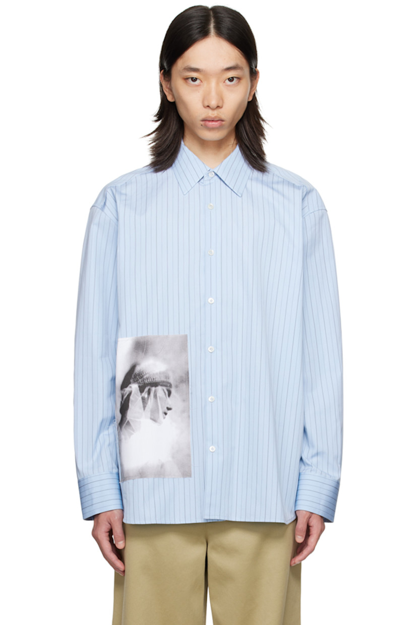 Cotton poplin shirt. Stripes throughout.

· Spread collar
· Button closure
· Graphic patch at front
· Shirttail hem
· Single-button barrel cuffs
· Patch at back collar

Supplier color: New Lanvin blue