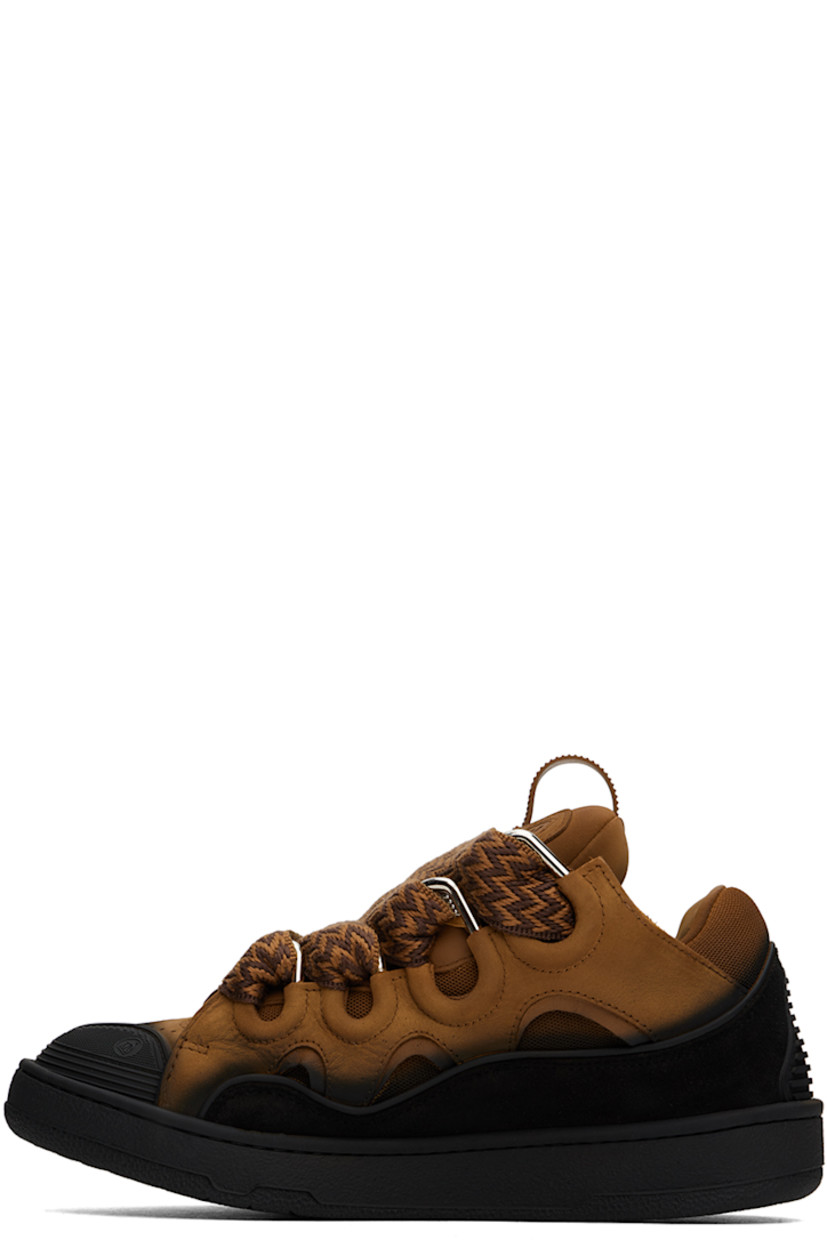 Low-top calfskin suede and mesh sneakers in tan and black. Spray paint effect throughout. 

· Piping, cutouts, and rubberized trim throughout
· Perforated detailing at toe
· Lace-up closure
· Pull-loop and embossed logo at tongue
· Padded tongue and collar
· Logo embossed at outer side
· Jersey lining
· Treaded rubber sole

Available exclusively at SSENSE.

Supplier color: Brown/Black