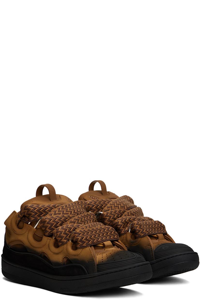 Low-top calfskin suede and mesh sneakers in tan and black. Spray paint effect throughout. 

· Piping, cutouts, and rubberized trim throughout
· Perforated detailing at toe
· Lace-up closure
· Pull-loop and embossed logo at tongue
· Padded tongue and collar
· Logo embossed at outer side
· Jersey lining
· Treaded rubber sole

Available exclusively at SSENSE.

Supplier color: Brown/Black