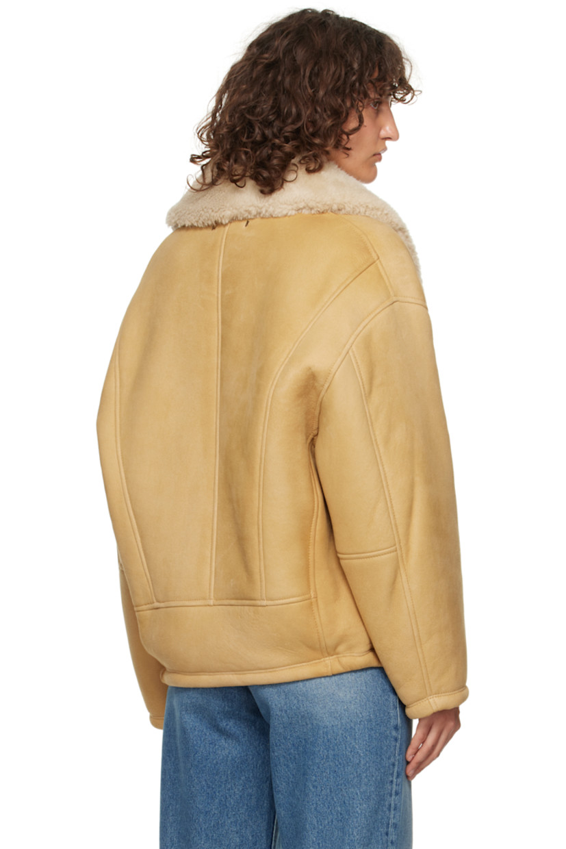 Sheepskin suede jacket.

· Shearling trim at shawl lapel
· Two-button closure
· Welt pockets
· Dropped shoulders
· Logo hardware at back collar
· Full shearling lining

Part of the Journey collection.

Supplier color: Lark