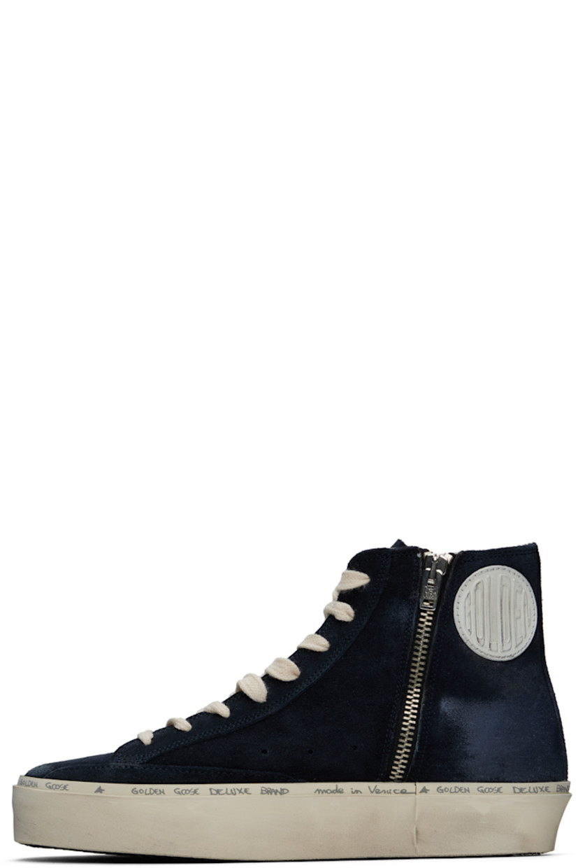 Handcrafted high-top suede sneakers in navy. Smudging throughout.

· Lace-up closure
· Logo embossed at tongue
· Perforated detailing at sides
· Zip closure at inner side
· Rubberized logo patch at inner side
· Signature star appliqué at outer side
· Logo stamp at outer side
· Terrycloth lining
· Logo and text printed at welt
· Treaded rubber sole

Supplier color: Blue/Silver