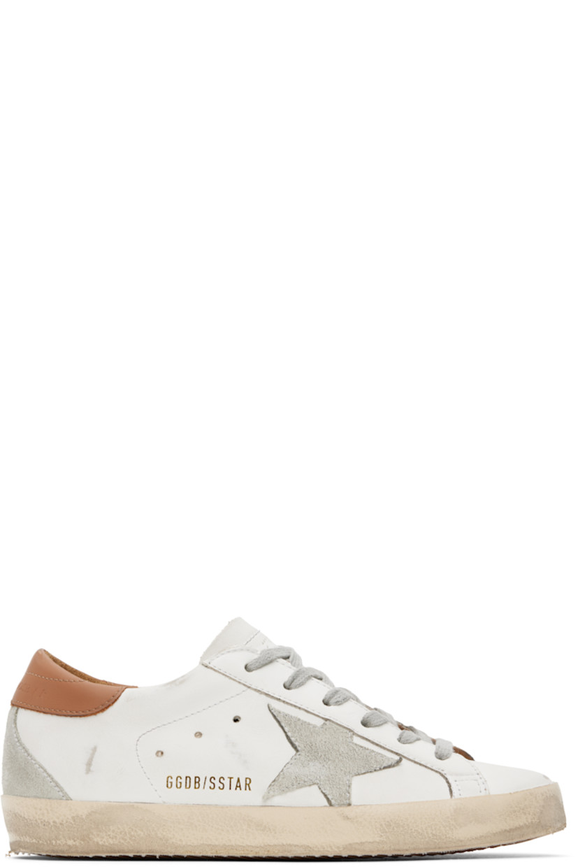Handcrafted low-top buffed leather sneakers in white.

· Smudging throughout
· Lace-up closure
· Perforated logo at tongue
· Padded collar
· Perforated detailing at sides
· Suede signature star appliqué at outer side
· Gold-tone logo stamp
· Logo embossed at heel tab 
· Suede trim at heel counter
· Terrycloth and buffed leather lining
· Treaded rubber sole

Supplier color: White/Brown