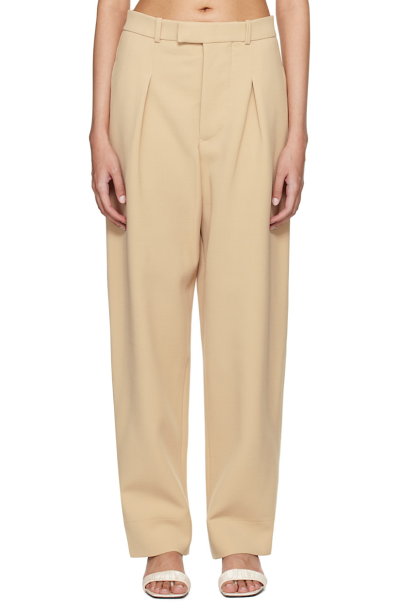 Wide-leg and tapered virgin wool bonded crepe trousers.

· Low-rise
· Belt loops
· Three-pocket styling
· Button-fly
· Pleats at front

Part of the WARDROBE.NYC x Hailey Bieber collaboration.

Supplier color: Biscuit