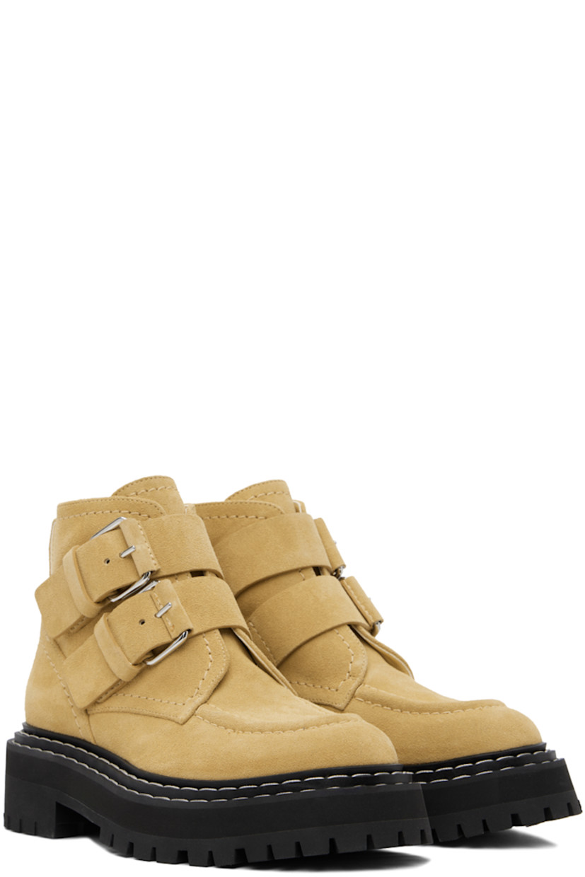 Ankle-high suede boots in beige.

· Moc toe
· Pin-buckle straps at vamp
· Pull-loop at heel counter
· Grained leather lining
· Topstitching in white at welt
· Foam rubber midsole
· Treaded rubber sole
· Heel: H1.5"

Supplier color: Dark beige