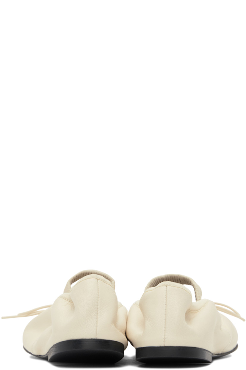 Crinkled leather Mary Jane-style ballerina flats in off-white.

· Self-tie bow accent at vamp
· Elasticized strap and collar
· Logo embossed at grained leather footbed
· Grained leather lining
· Rubber sole

Supplier color: Natural
