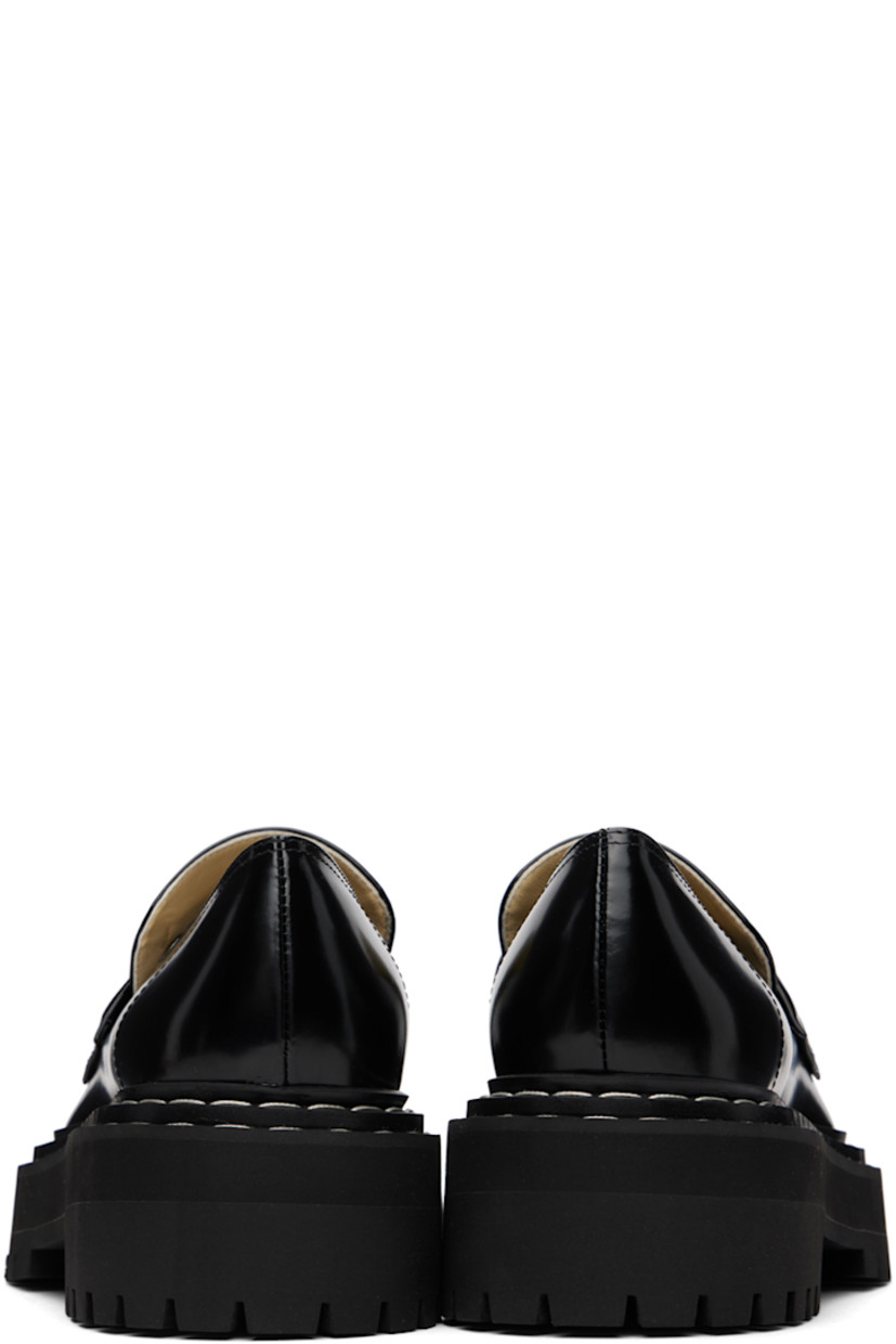 Polished calfskin loafers in black. 

· Moc toe
· Strap at vamp
· Topstitching at tiered welt
· Grained leather and suede lining
· Foam rubber platform midsole
· Lugged rubber sole
· Platform: H1.25"
· Heel: H2"

Supplier color: Black
