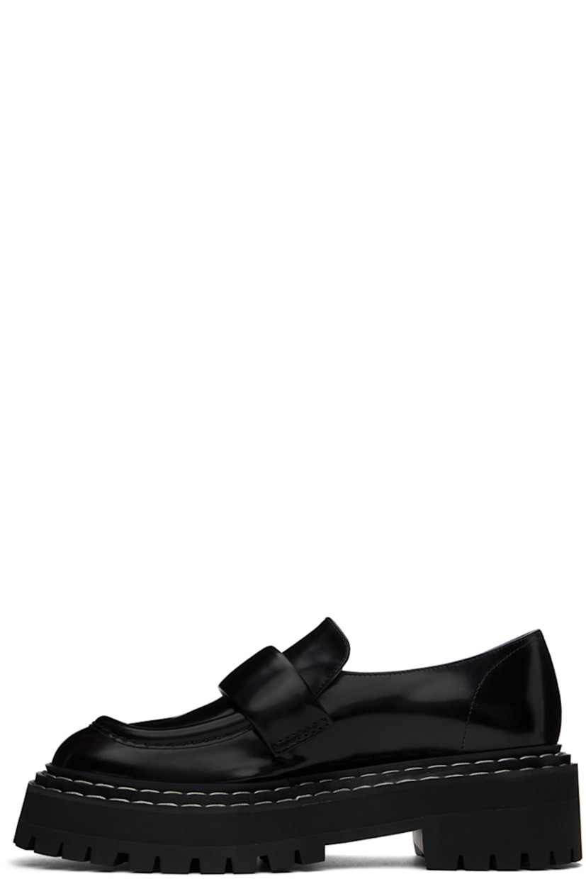 Polished calfskin loafers in black. 

· Moc toe
· Strap at vamp
· Topstitching at tiered welt
· Grained leather and suede lining
· Foam rubber platform midsole
· Lugged rubber sole
· Platform: H1.25"
· Heel: H2"

Supplier color: Black