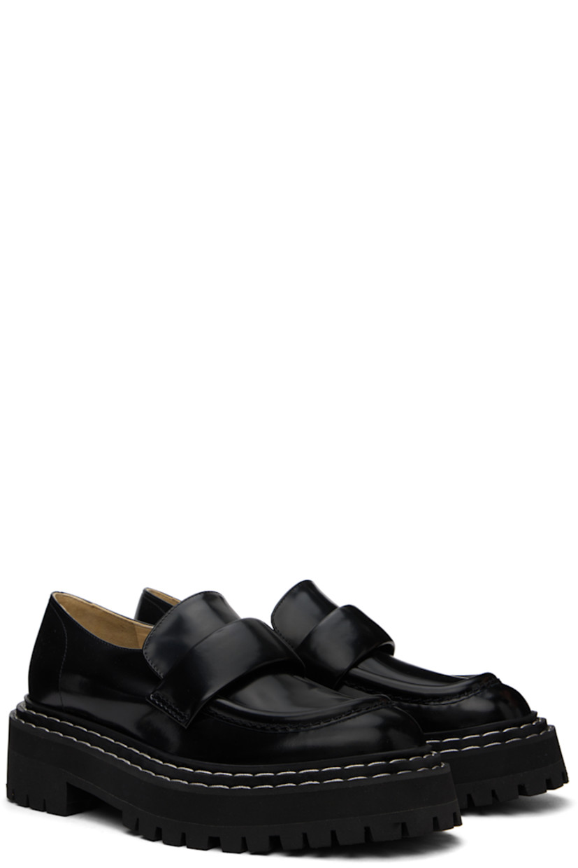 Polished calfskin loafers in black. 

· Moc toe
· Strap at vamp
· Topstitching at tiered welt
· Grained leather and suede lining
· Foam rubber platform midsole
· Lugged rubber sole
· Platform: H1.25"
· Heel: H2"

Supplier color: Black