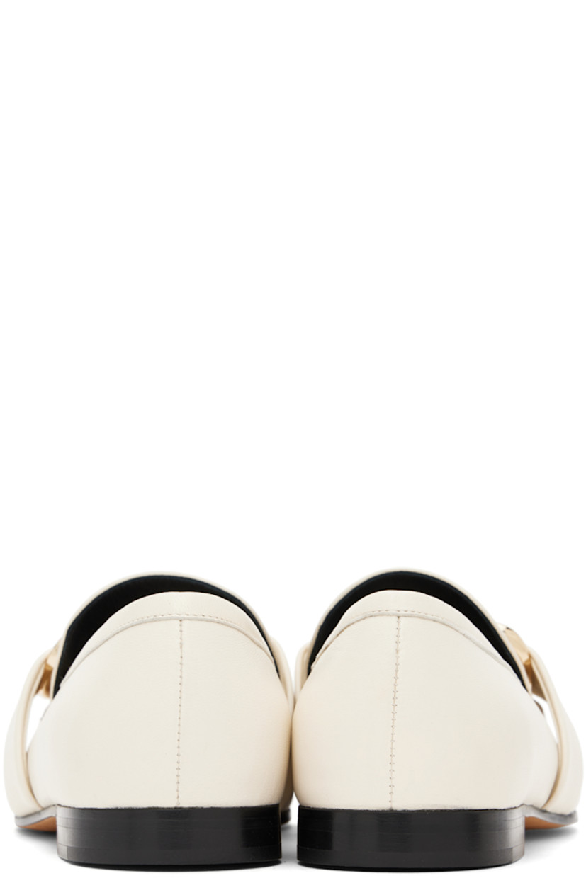 Buffed calfskin loafers in off-white.

· Moc toe
· Logo hardware at vamp
· Buffed leather and suede lining
· Stacked leather heel with rubber injection
· Suede sole

Supplier color: Cream