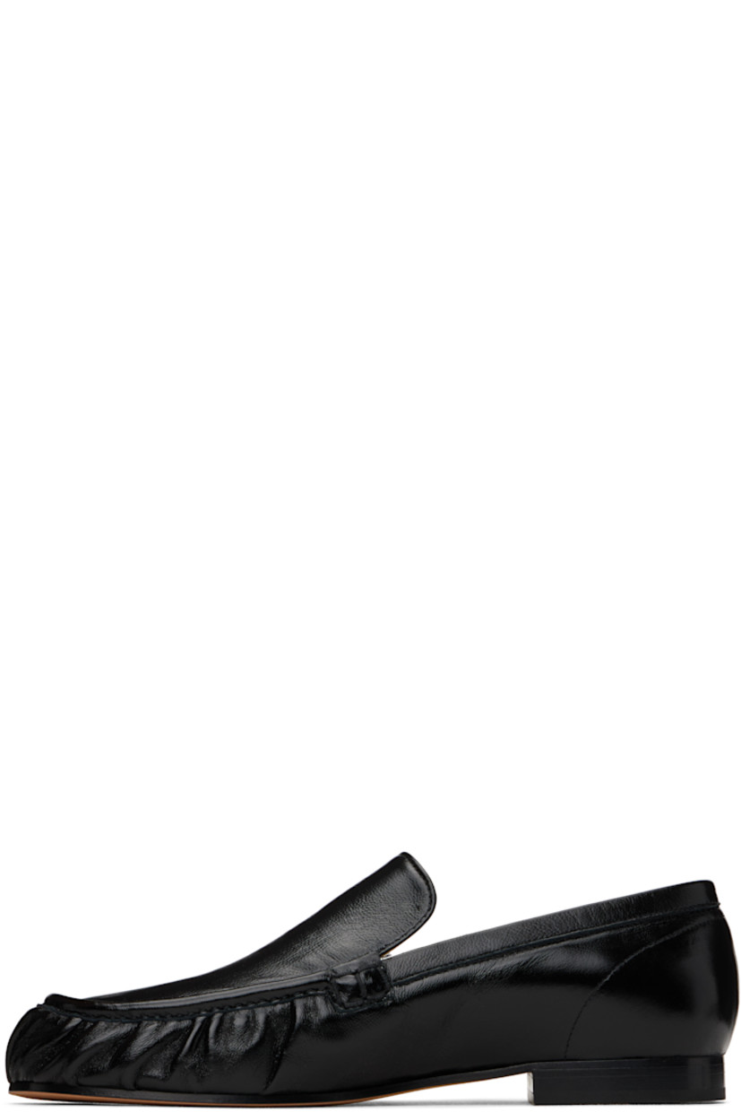 Buffed lambskin loafers in black.

· Pintucks at moc toe
· Silver-tone logo hardware at tongue
· Logo stamp at leather footbed
· Leather and suede lining
· Leather sole

Supplier color: Black