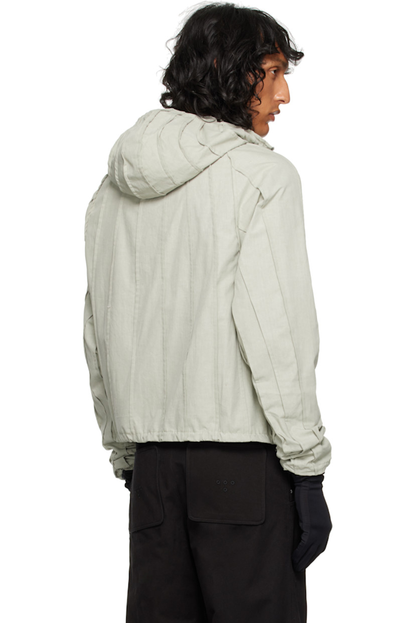 Cotton canvas jacket. Pinched seams throughout. 

· Funnel neck
· Zip closure
· Seam pockets
· Bungee-style drawstring at hem and cuffs
· Raglan sleeve

Supplier color: Laurel oak