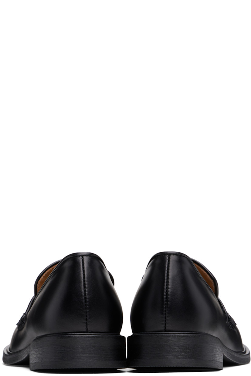 Buffed leather loafers in black.

· Moc toe
· Strap at vamp
· Cushioned Ortholite® footbed
· Buffed leather and suede lining
· Stacked leather heel and midsole
· Textured Vibram® rubber sole
· Heel: H1"

Supplier color: Black