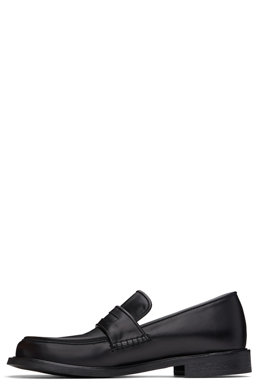 Buffed leather loafers in black.

· Moc toe
· Strap at vamp
· Cushioned Ortholite® footbed
· Buffed leather and suede lining
· Stacked leather heel and midsole
· Textured Vibram® rubber sole
· Heel: H1"

Supplier color: Black