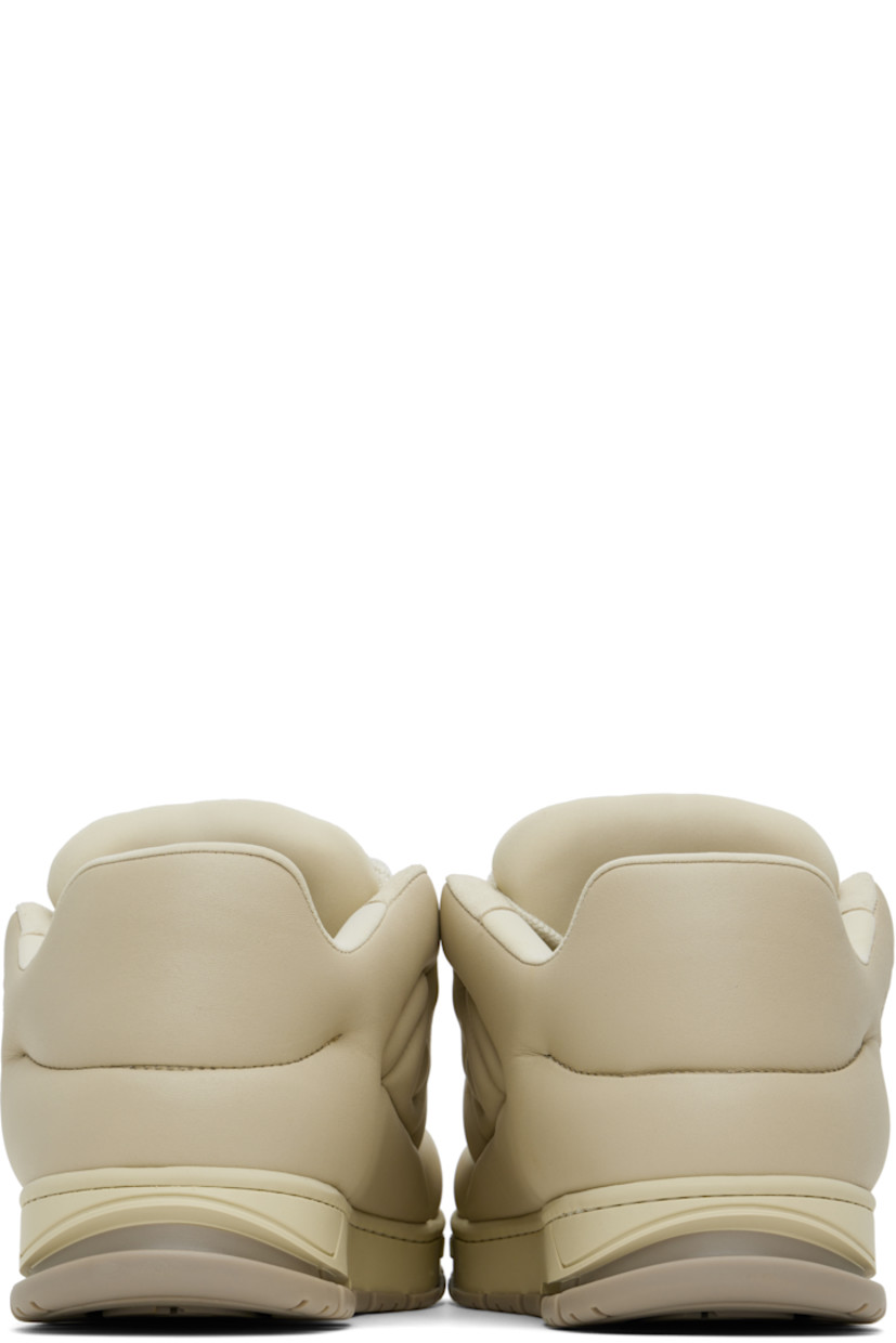 Low-top quilted buffed leather sneakers in beige. 

· Handcrafted
· Perforated detailing at toe
· Lace-up closure
· Logo embossed at padded tongue
· Padded collar
· TPU heel clip
· Jersey lining 
· Logo embossed at textured rubber midsole
· Treaded rubber sole

Supplier color: Off-white/Beige