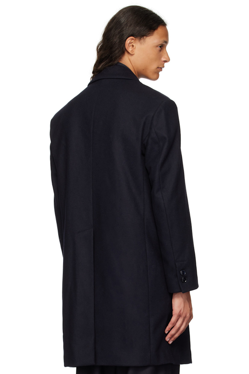 Heavyweight wool-blend barathea coat.

· Peaked lapel
· Double-breasted button closure
· Welt pocket and flap pockets
· Two-button surgeon's cuffs
· Central vent at back hem
· Patch pocket at interior
· Partially lined

Supplier color: Navy