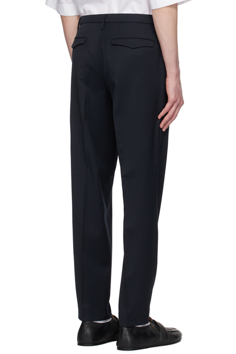 Slim-fit stretch plain-woven virgin wool trousers. 

· Mid-rise
· Belt loops
· Four-pocket styling
· Zip-fly
· Pleats at front
· Creased legs 
· Button tabs at back waistband

Supplier color: Navy