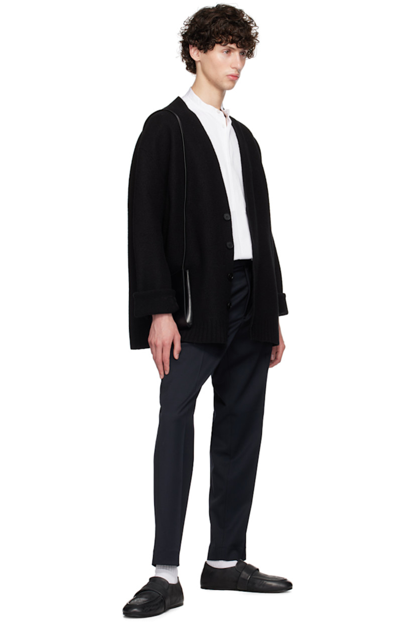 Slim-fit stretch plain-woven virgin wool trousers. 

· Mid-rise
· Belt loops
· Four-pocket styling
· Zip-fly
· Pleats at front
· Creased legs 
· Button tabs at back waistband

Supplier color: Navy
